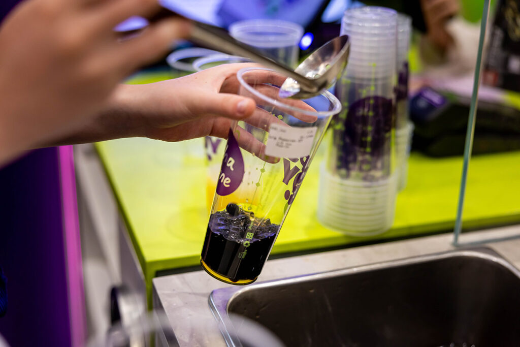 Chatime team member preparing bubble tea with tapioca pearls inside an Australian franchise store